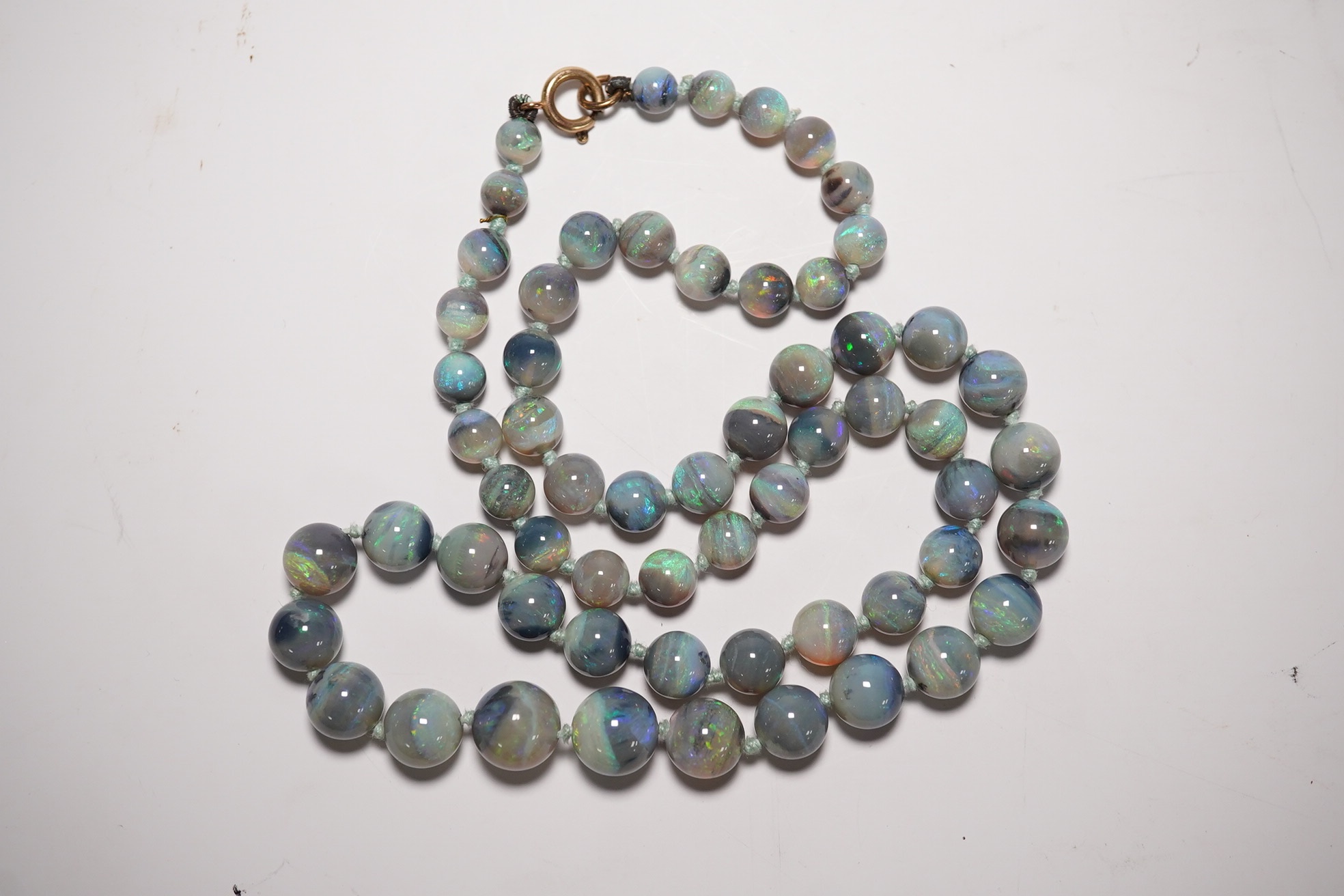 A single strand graduated blue opal bead necklace, with 9ct clasp, retailed by Liberty & Co?, 44cm, with Liberty & Co box. Condition - fair to good